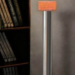 Close-up of a silver metal pole with an orange fabric-wrapped cap, beside a dark bookshelf.