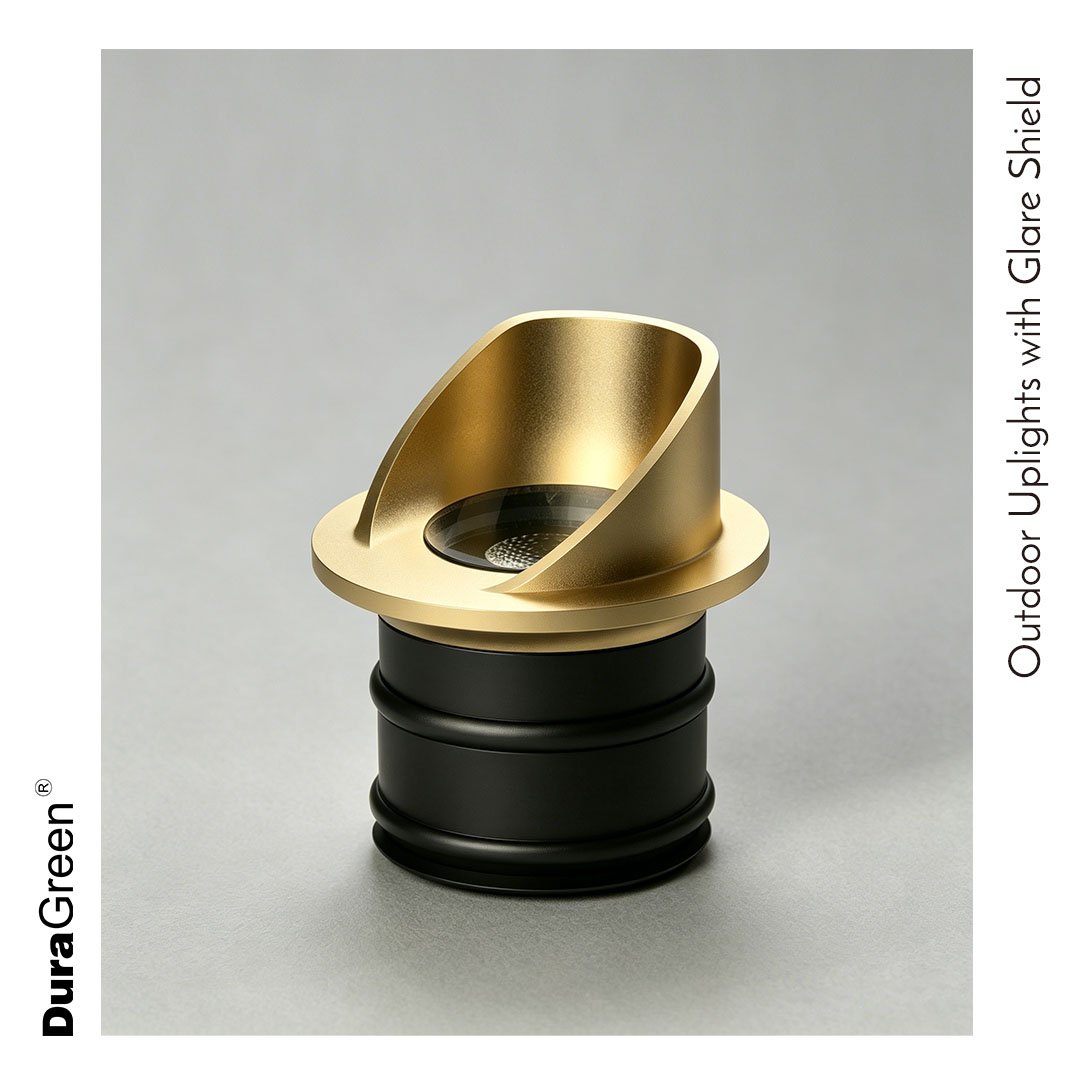 Gold outdoor uplight with a glare shield atop a black base, designed for landscape lighting.