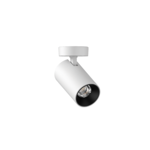 White cylindrical ceiling spotlight mounted to a track, angled downward to illuminate a space.